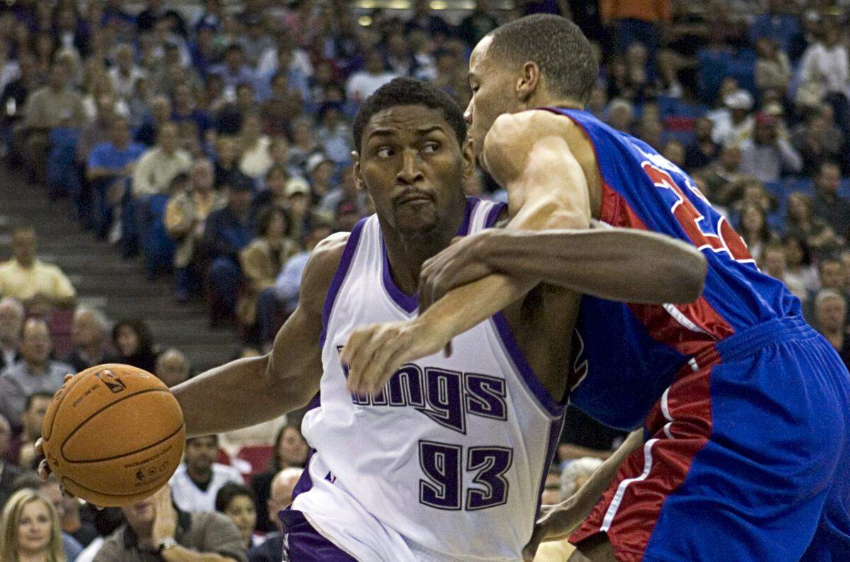 The Sacramento Kings’ Ron Artest locks arms as he tries to drive past the Detroit Pistons’ Tayshaun Price at Arco Arena in Sacramento on Nov. 8, 2006. 