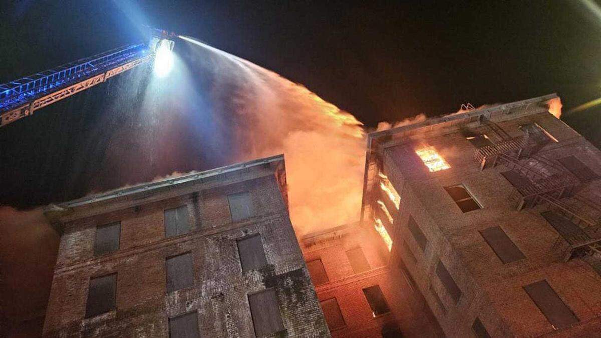 Firefighters work to douse flames from the top floor of the Hotel Marysville, which ignited Saturday, June 15, 2024, and burned through the night as crews worked against flames and the vacant landmark’s structural integrity. Firefighters said Sunday that the building was still smoldering and that engineers would be required to determine if the building was salvageable.