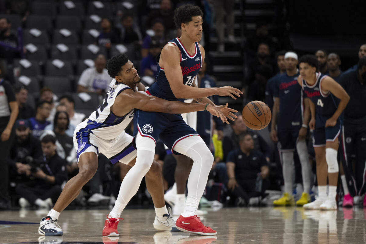 Sacramento Kings center Dylan Cardwell (32) fights for the ball with LA Clippers center Yanic Konan Niederhäuser (14) during a game between the Kings and the Clippers at Golden 1 Center in Sacramento on Wednesday, Oct. 15, 2025.