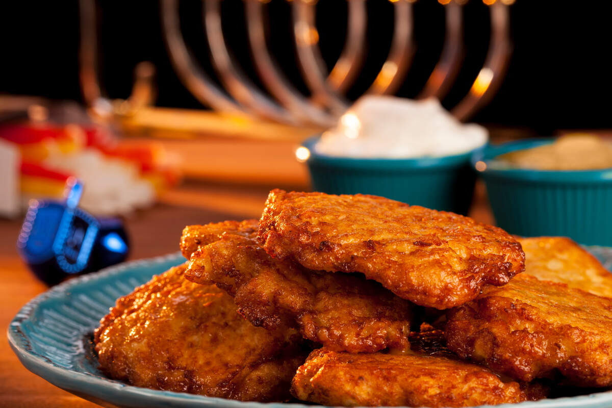 Potato latkes, served with sour cream and apple sauce, is a traditional Hanukkah meal.