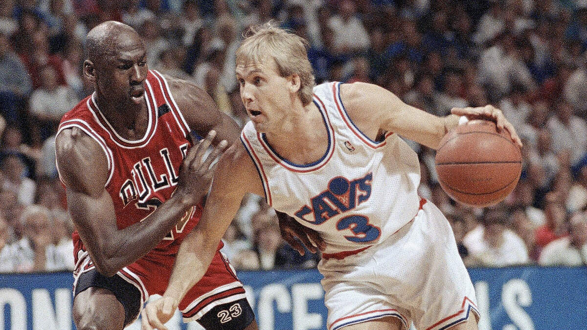 FILE - In this May 25, 1992 file photo Cleveland Cavaliers guard Craig Ehlo (3) drives past Michael Jordan of the Chicago Bulls during an Eastern Conference Championship basketball game in Richfield, Ohio. Ehlo still believes he played great defense. He shared an ultimate moment with Michael Jordan, and Jordan came out on top each time. He’ll be on highlight reels forever and “The Last Dance” — the ESPN and Netflix 10-part documentary series about Jordan’s Chicago Bulls that ends on Sunday, May 17, 2020 only freshened the familiarity fans have with two of the most-replayed shots in NBA history. (AP Photo/Mark Duncan)