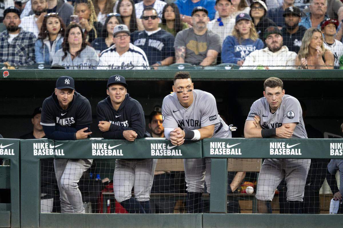 New York Yankees right fielder Aaron Judge, second from right, watches the game from the visitors dugout against the Athletics on Friday at Sutter Health Park in West Sacramento.