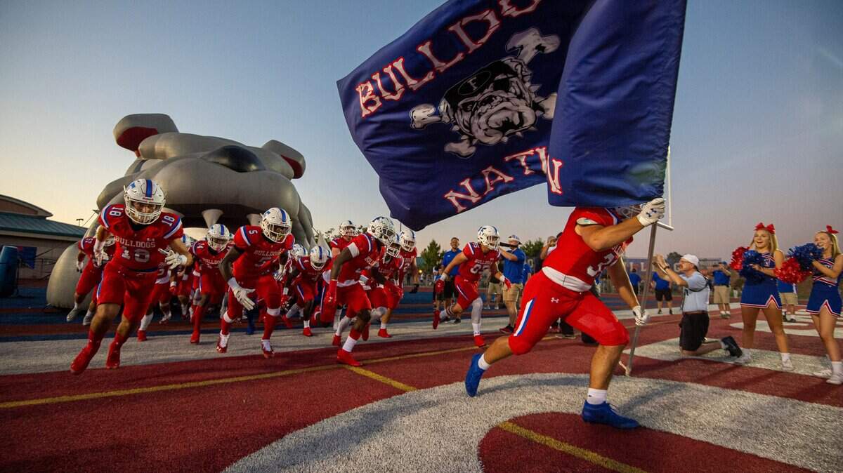 The Folsom Bulldogs come on the field before the game as they host the De La Salle Spartans on Friday, Sept. 13, 2019.