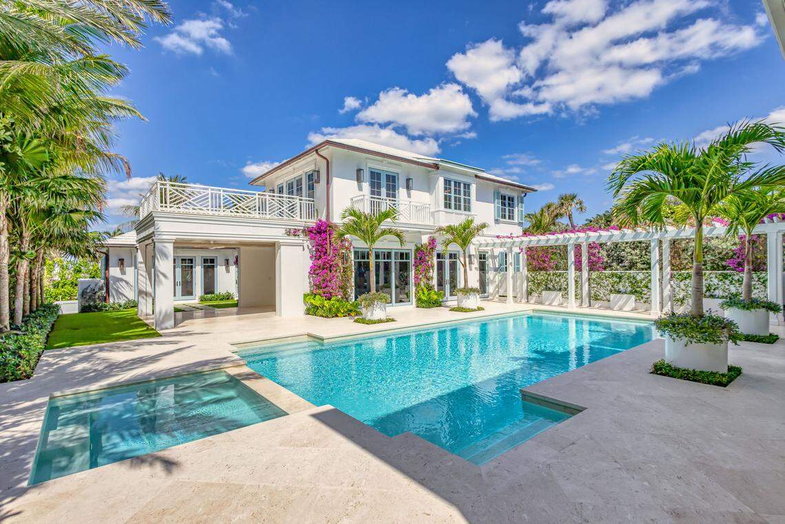 The 16,500-square-foot property features a main residence and guest house connected by lush landscaping and a resort-style courtyard with a pool, spa and summer kitchen.