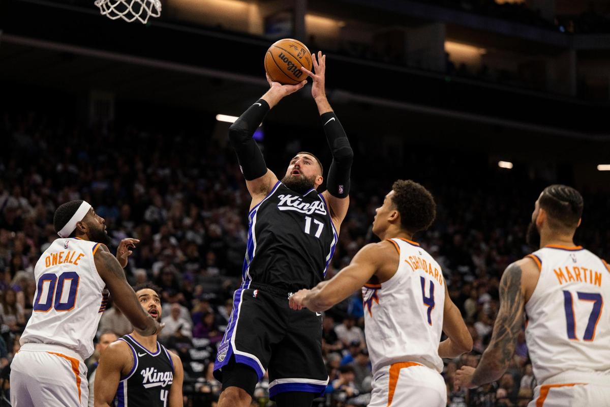 Sacramento Kings center Jonas Valanciunas (17) makes a basket as he’s fouled by Phoenix Suns center Oso Ighodaro (4) during an NBA game at Golden 1 Center on Sunday, April 13, 2025.