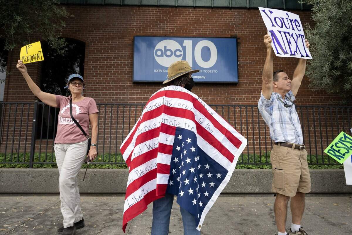 Sara Nichols, left, Elizabeth Trudeau, center, and Kit Tyler protest the removal of late-night talk host Jimmy Kimmel from ABC’s network outside of KXTV, the local affiliate known as ABC10, on Thursday in Sacramento. Kimmel was pulled indefinitely for remarks about the politics of the man who is accused of killing conservative activist Charlie Kirk. Channel 10 is not owned by ABC or its parent, Disney.
