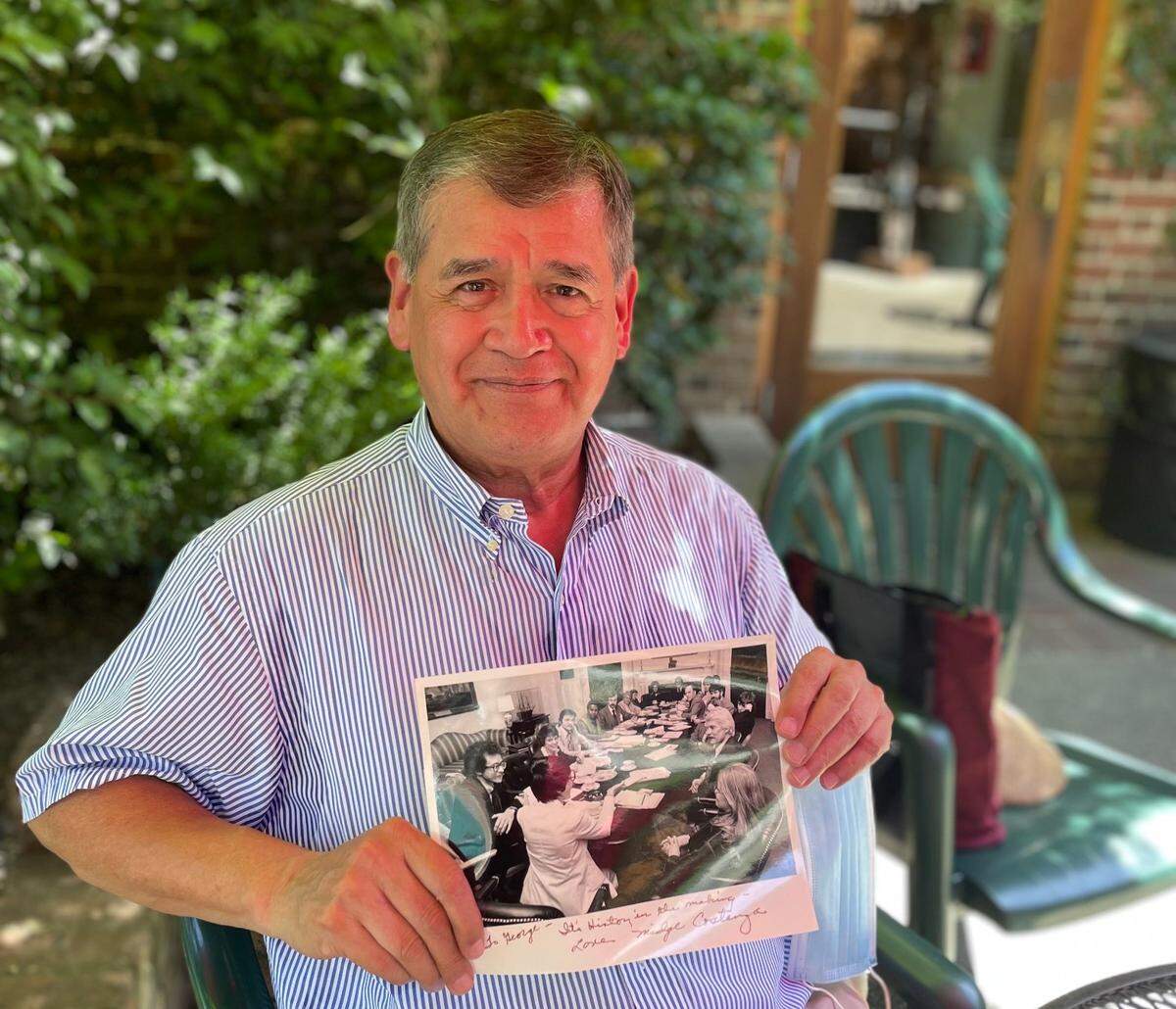 George Raya sits at Old Soul at The Weatherstone cafe in Sacramento on Thursday, June 9, 2022, holding a 1977 photo of himself and others in the National Gay Task Force meeting at the White House. Raya’s 75th birthday party in 2024 raised funds for the Placer LGBTQ+ Center, which continues to seek recurring donations and long-term support for its new permanent facility.