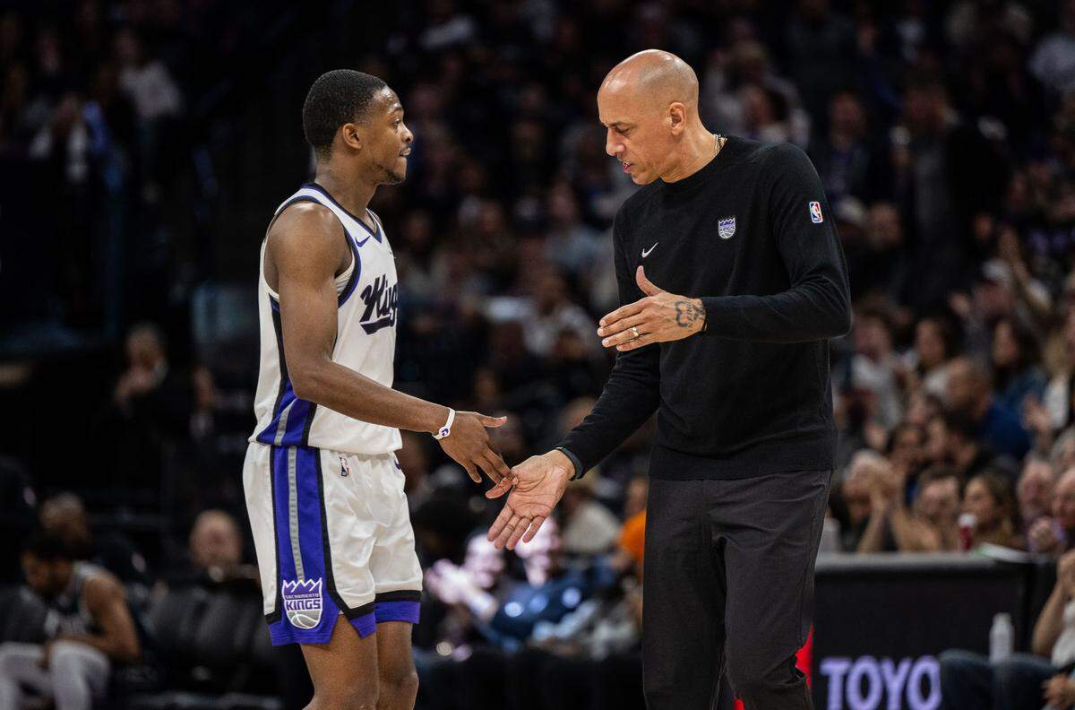 Sacramento Kings guard De’Aaron Fox (5) shakes hands with interim coach Doug Christie, who won his first game as head coach, during an NBA game against the Dallas Mavericks on Monday.