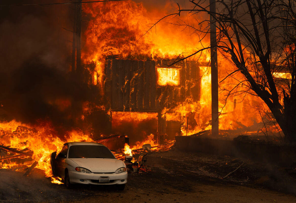 A home burns on Highway 89 south of Greenville near Forgay Road during the Dixie Fire on Thursday, Aug. 5, 2021.