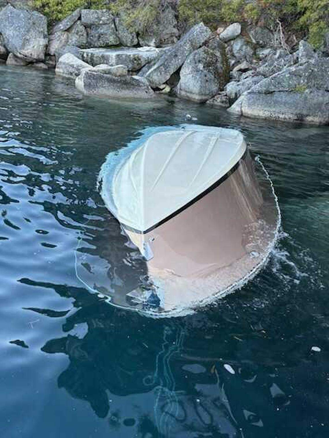 The overturned 27-foot Chris-Craft floats partially submerged near D.L. Bliss State Park on Lake Tahoe on June 21. The boat capsized in high winds and rough swells, leaving eight people dead.