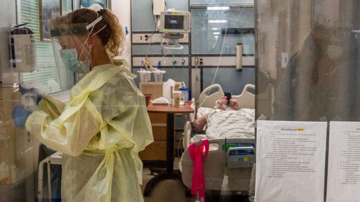 Physical therapist Kim Dennies works inside a modified room for overflow COVID-19 patients in the north ICU at Marshall Medical Center’s hospital in Placerville on Wednesday, Dec. 2, 2020.