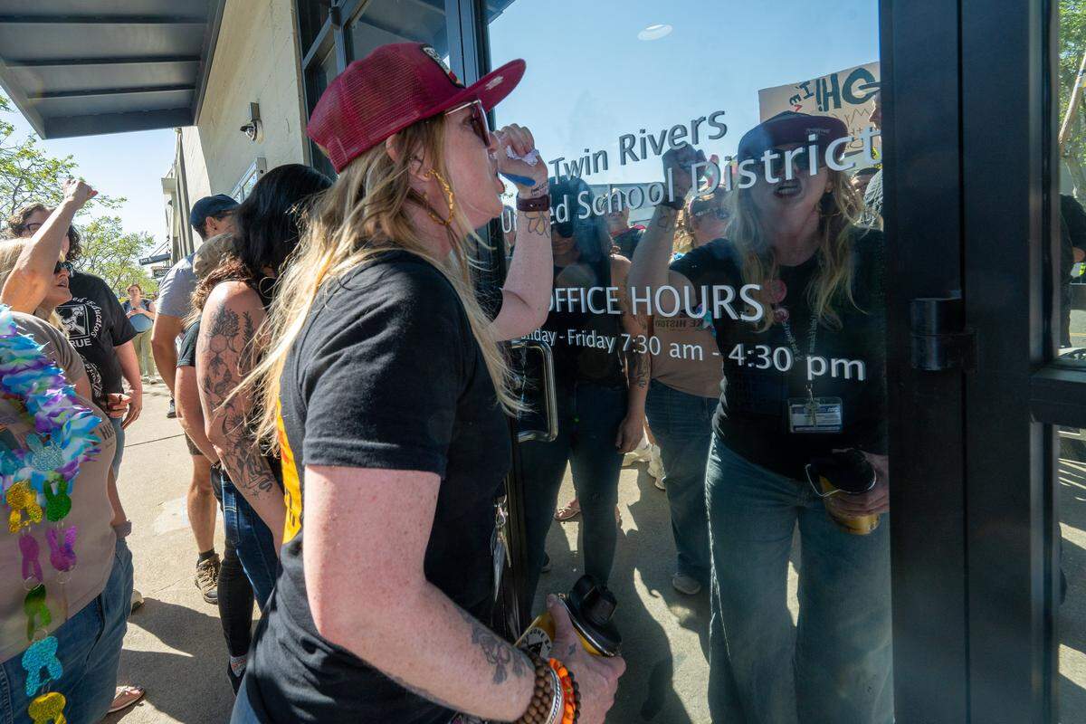 Brittoni Ward, president of the Twin Rivers teachers union, pounds Friday on the door of the Twin Rivers Unified School District office, demanding that the district return to the table as the teacher strike reached its 12th day of instruction.