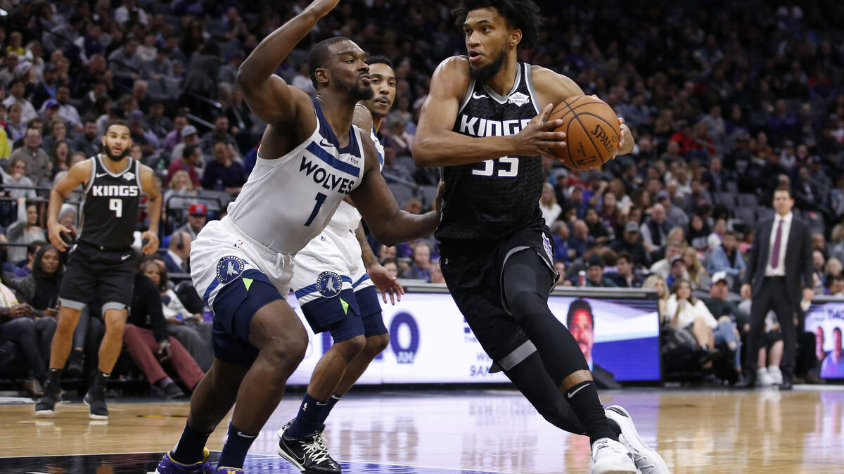 Sacramento Kings forward Marvin Bagley III, right, goes to the basket against Minnesota Timberwolves forward Noah Vonleh, left during the second half of an NBA basketball game in Sacramento, Calif., Thursday, Dec. 26, 2019. The Timberwolves won, in double-overtime, 105-104.(AP Photo/Rich Pedroncelli)