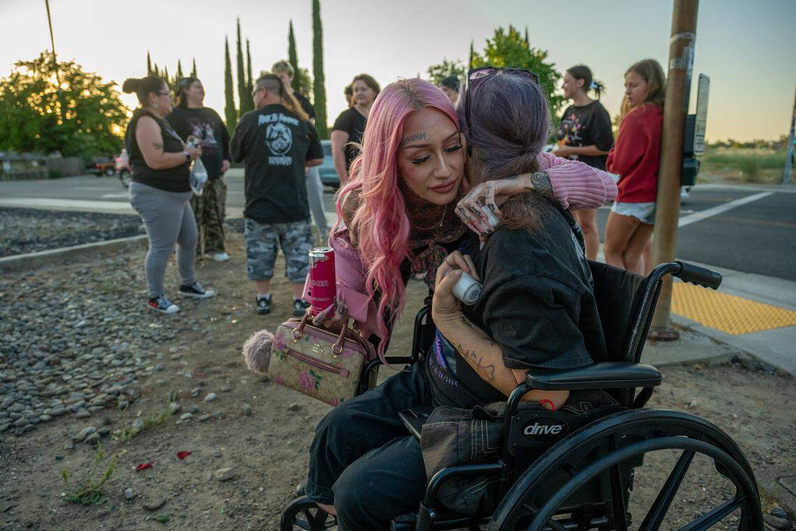 Erika Pringle, left, who lost her brother when he was struck by a driver who ran a red light, hugs Marie Martinez, whose son, Shawn Jordan, was also killed when he was struck by a car, on June 20. They both said the only good thing that came out of the deaths of their loved ones was their friendship.