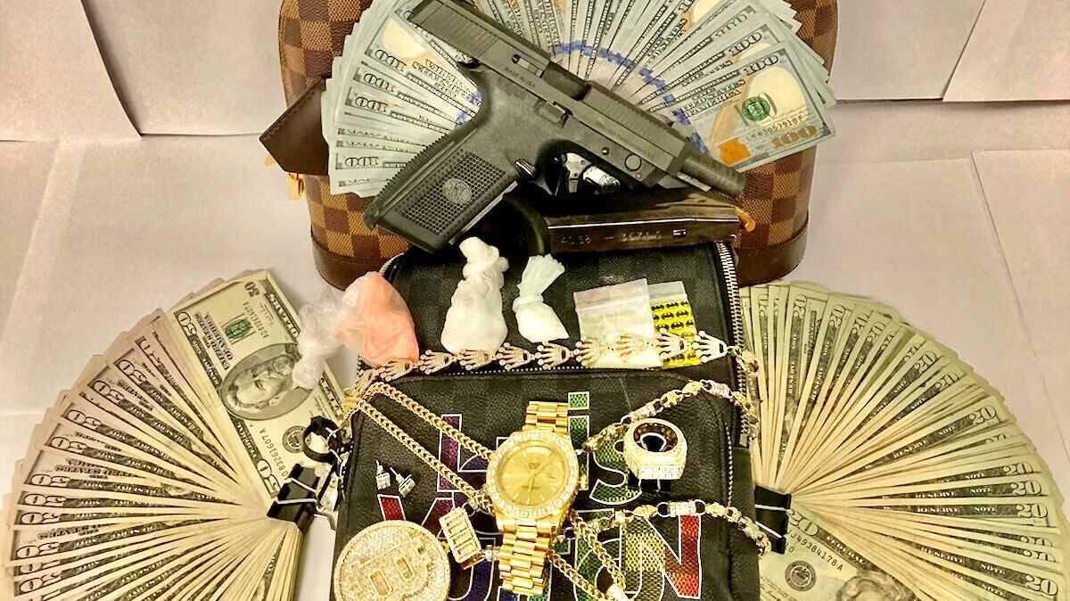 Cash, drugs, jewelry and a loaded firearm are seen in an undated photograph provided by the Roseville Police Department in connection with a traffic stop seizure that is part of an ongoing multi-agency investigation of a criminal ring involving weapons, EDD fraud and human trafficking.