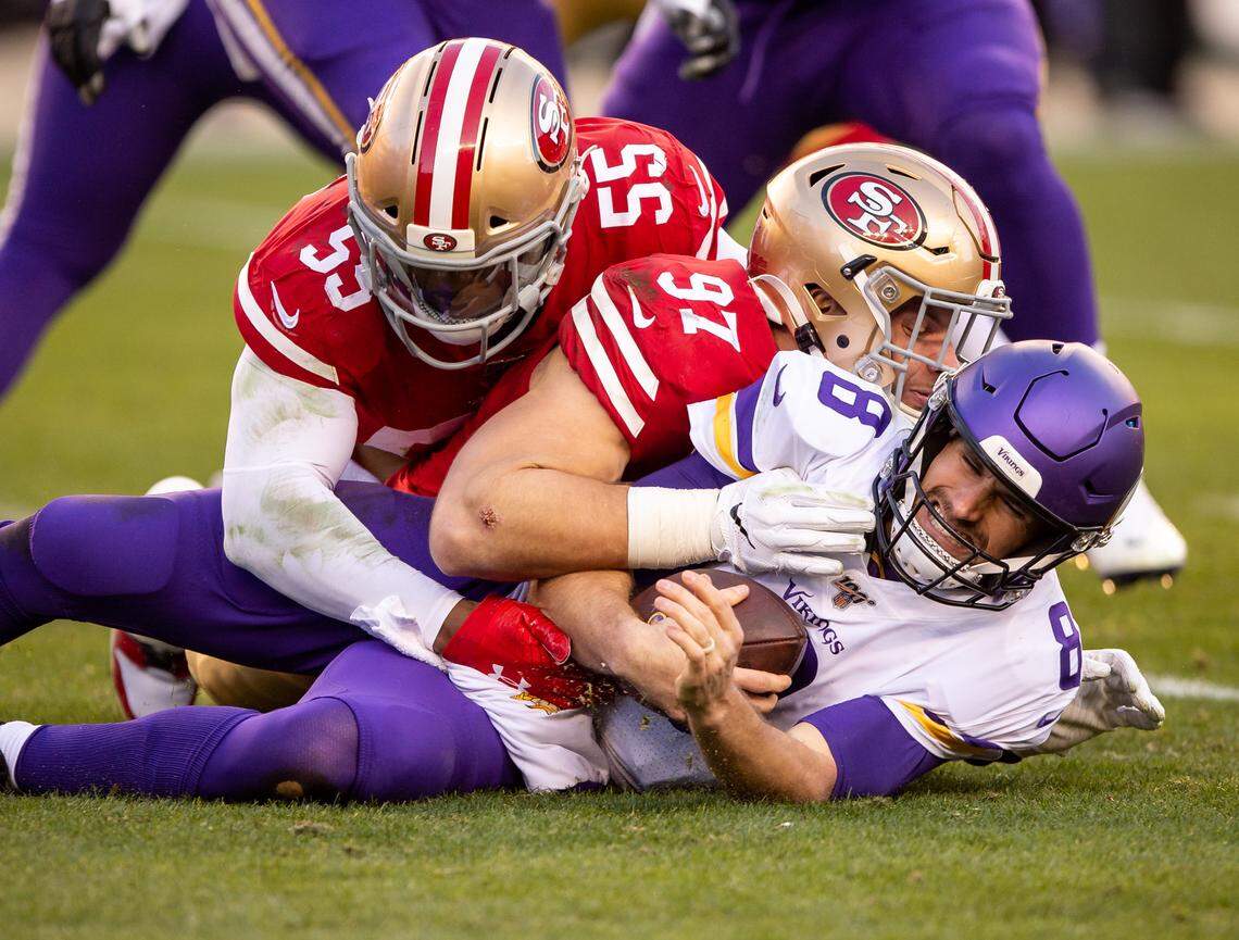 Minnesota Vikings quarterback Kirk Cousins (8) is sacked by San Francisco 49ers defensive end Nick Bosa (97), center, with help from defensive end Dee Ford (55) during the fourth quarter of the NFC playoff game Saturday, Jan. 11, 2020, at Levi’s Stadium in Santa Clara. The 49ers beat the Vikings 27-10.