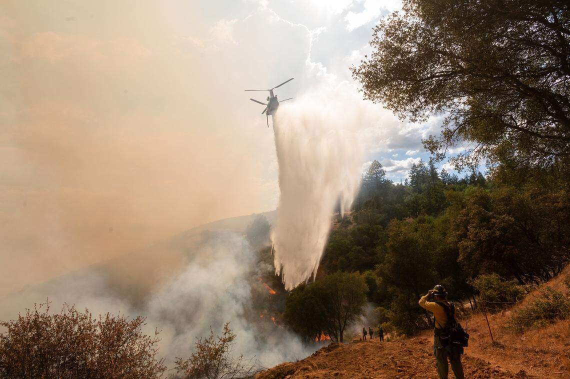 A Chinook helicopter drops water on the Electra Fire in Pine Grove in Amador County on Tuesday, July 5, 2022. The fire had burned over 3,000 acres and there are mandatory evacuations in Amador and Calaveras counties.