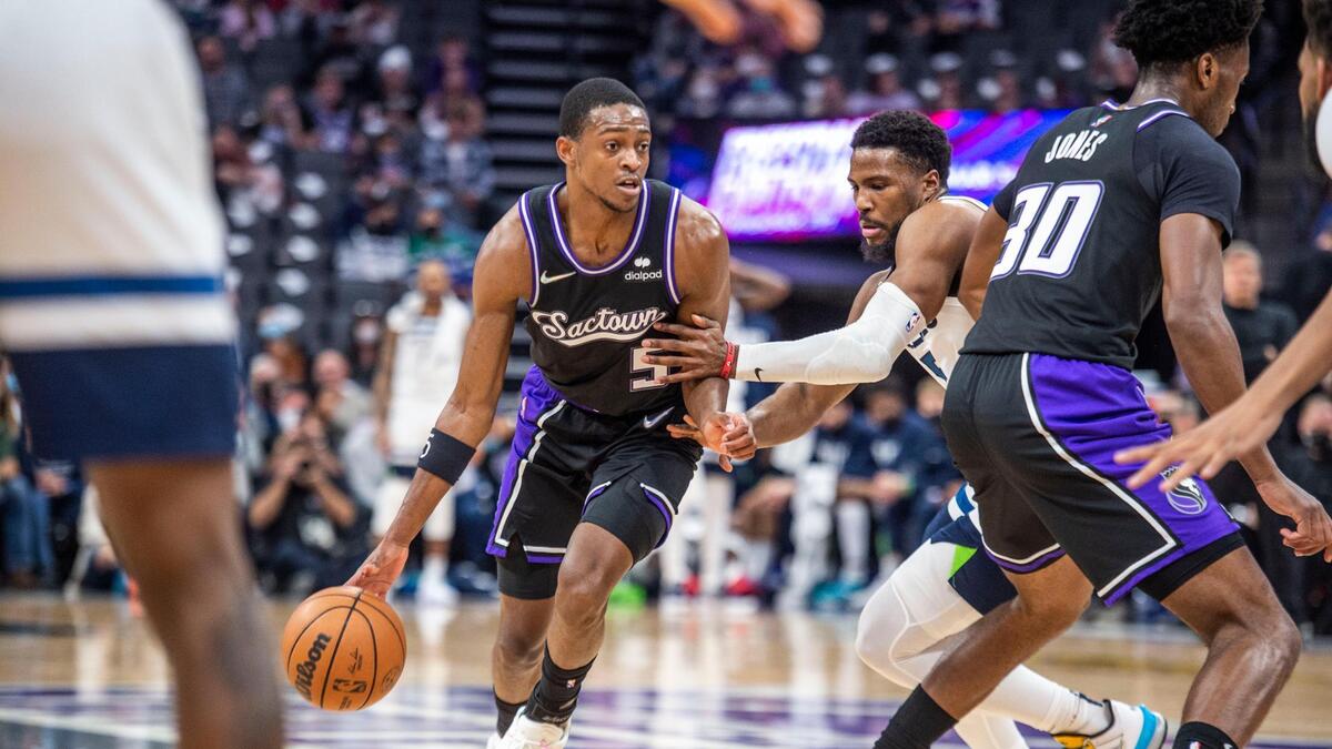 Sacramento Kings guard De’Aaron Fox (5) drives to the basket as he’s defended by Minnesota Timberwolves guard Malik Beasley (5) on Tuesday, Feb. 8, 2022 during an NBA game at Golden 1 Center in Sacramento.