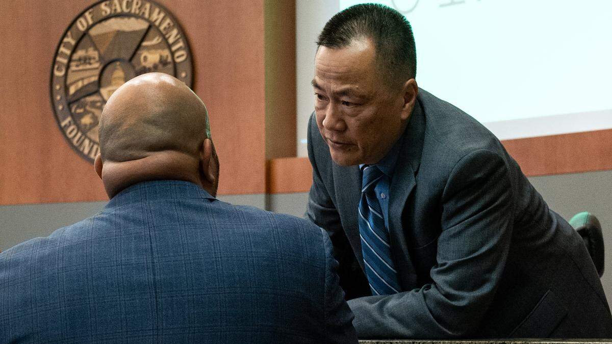 Sacramento City Manager Howard Chan leans over to chat with Assistant City Manager Mario Lara during a Sacramento City Council meeting about the homeless Tuesday, June 27, 2023.