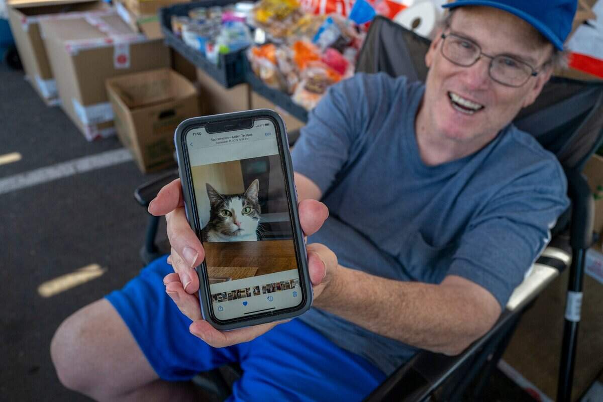 Warren Thompson, a Camp Fire survivor in 2018 who lost everything, said Thursday that he credits his cat Cinder, who has since died, for keeping him company on his harrowing 4-hour drive through flames the day he escaped the fire in Paradise. He now lives in Sacramento and has another cat. “I’ve been through this myself before so it would be good to come out and help as much as possible,” he said while volunteering at the Mosquito Fire evacuation center in Rocklin.