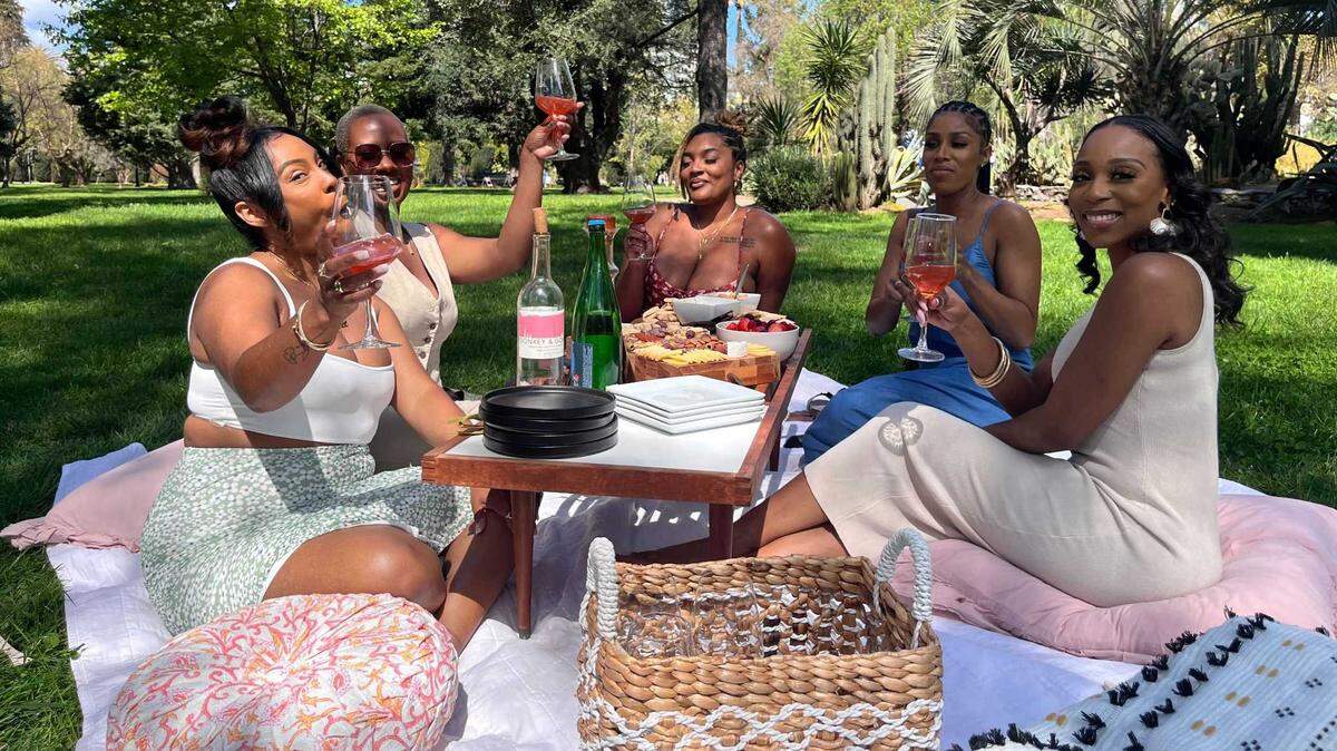 A group of women enjoy their outing at Eden Natty Wine Garden, featuring wine, assorted fruits, cheeses and crackers. The day party at Estate Farms in Vineyard returns Sunday with more than 30 wines and live music.