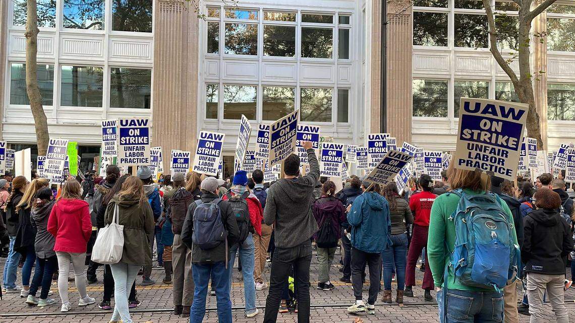 Hundreds of University of California academic workers on strike marched to a downtown Sacramento office building Monday Dec. 5, 2022, demanding administration officials return to the bargaining table.