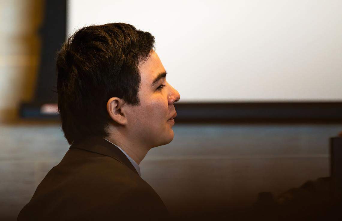 Carlos Reales Dominguez, the former UC Davis student accused of killing two and injuring a third in a series of knife attacks, smiles faintly as his younger sister Mia, 13, testifies that she didn’t recall his high school football team winning any games during his murder trial in Yolo Superior Court on Monday. Dominguez’s expression rarely changes during the trial. 