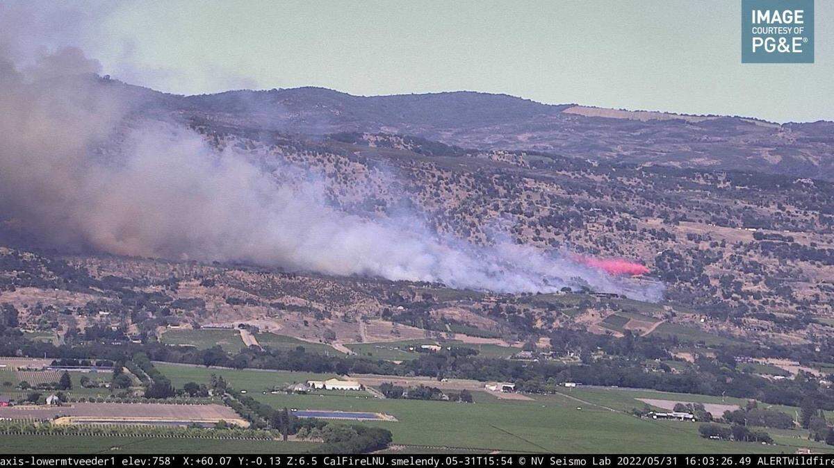 Retardant and smoke is seen billowing from the Old Fire, 5 miles north of Napa, Calif., along Soda Canyon Road, as seen from a PG&E wildfire camera on Tuesday, May 31, 2022.