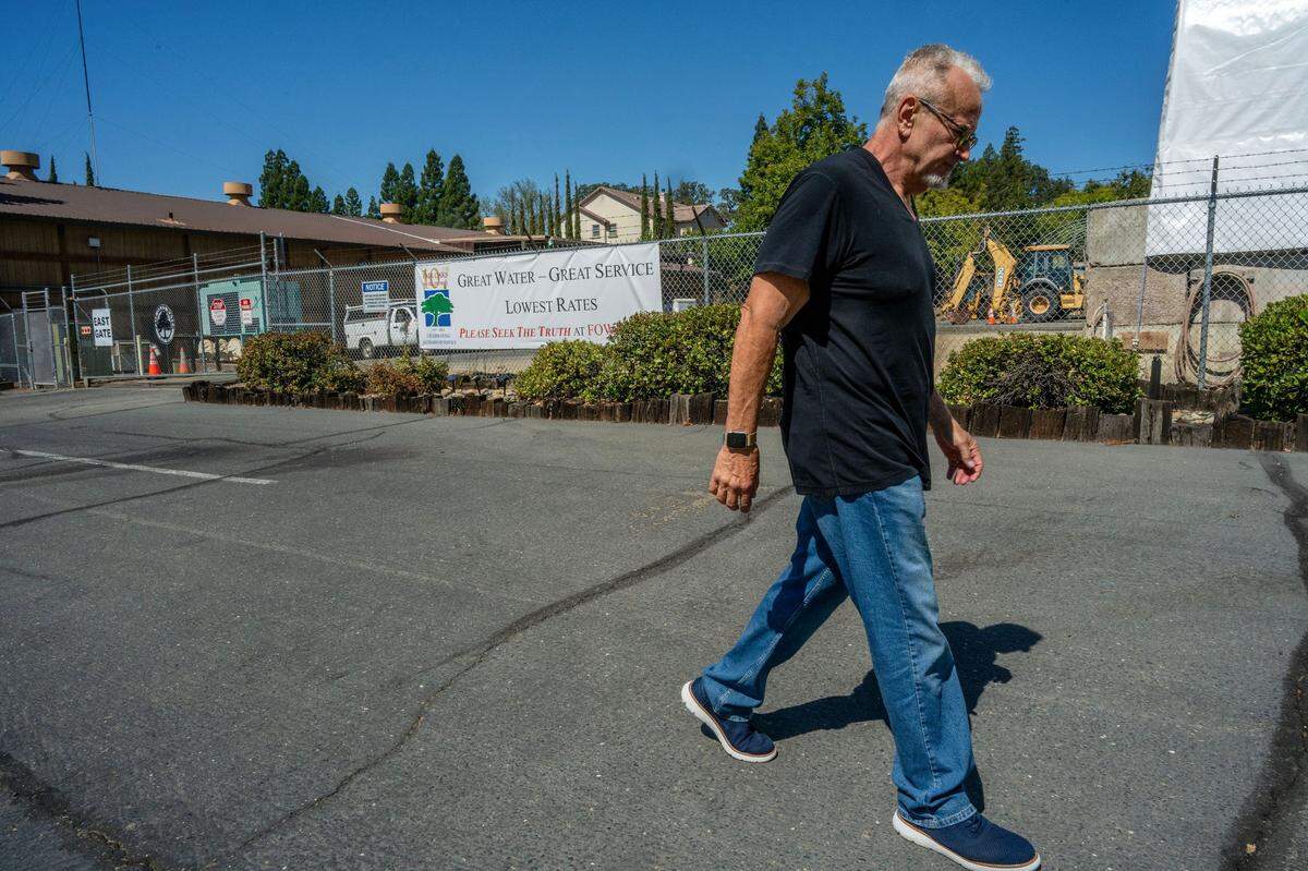 Leon Corcos walks past the Fair Oaks Water District’s corporate yard on Winding Way last month. “It’s the entrance to our community and it’s an eyesore,” said Corcos, who would like to see parking for the popular village dining district nearby replace the facility.