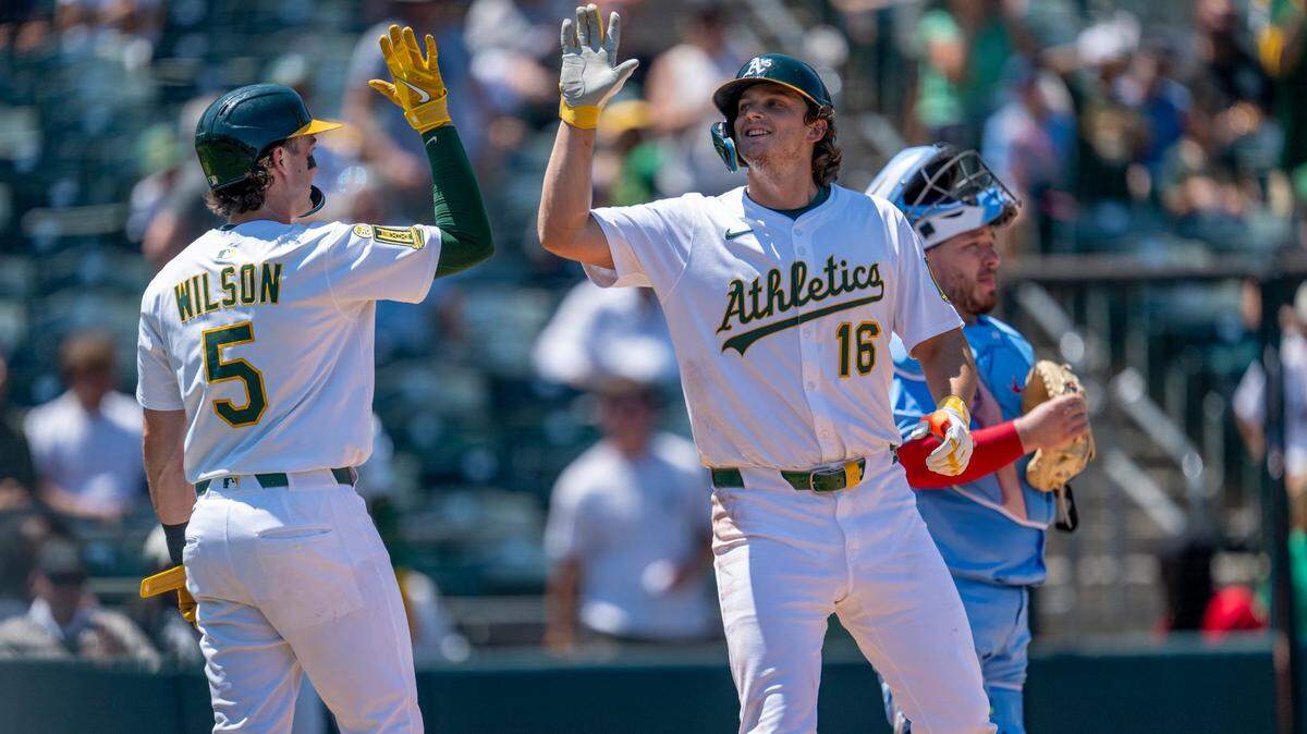 Athletics shortstop Jacob Wilson (5) high fives first baseman Nick Kurtz (16) after Kurtz hit a two-run home run in the fifth inning Sunday, July 13, 2025, against the Toronto Blue Jays at Sutter Health Park in West Sacramento. Recent betting odds have Kurtz as the favorite and Wilson with the second-best chance of winning American League Rookie of the Year.