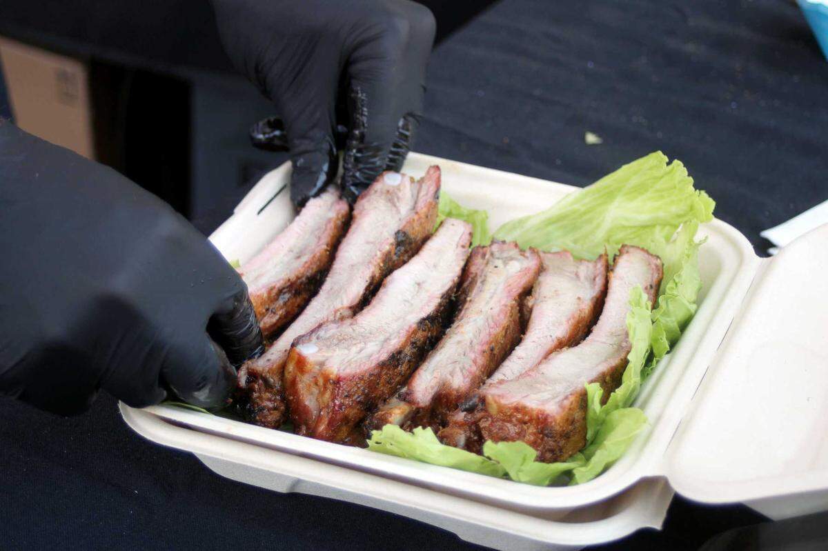 Char’D Pink pitmaster Tyler Klick prepares barbecue ribs for the California BBQ Compeition at the California State Fair on July 12, 2025.