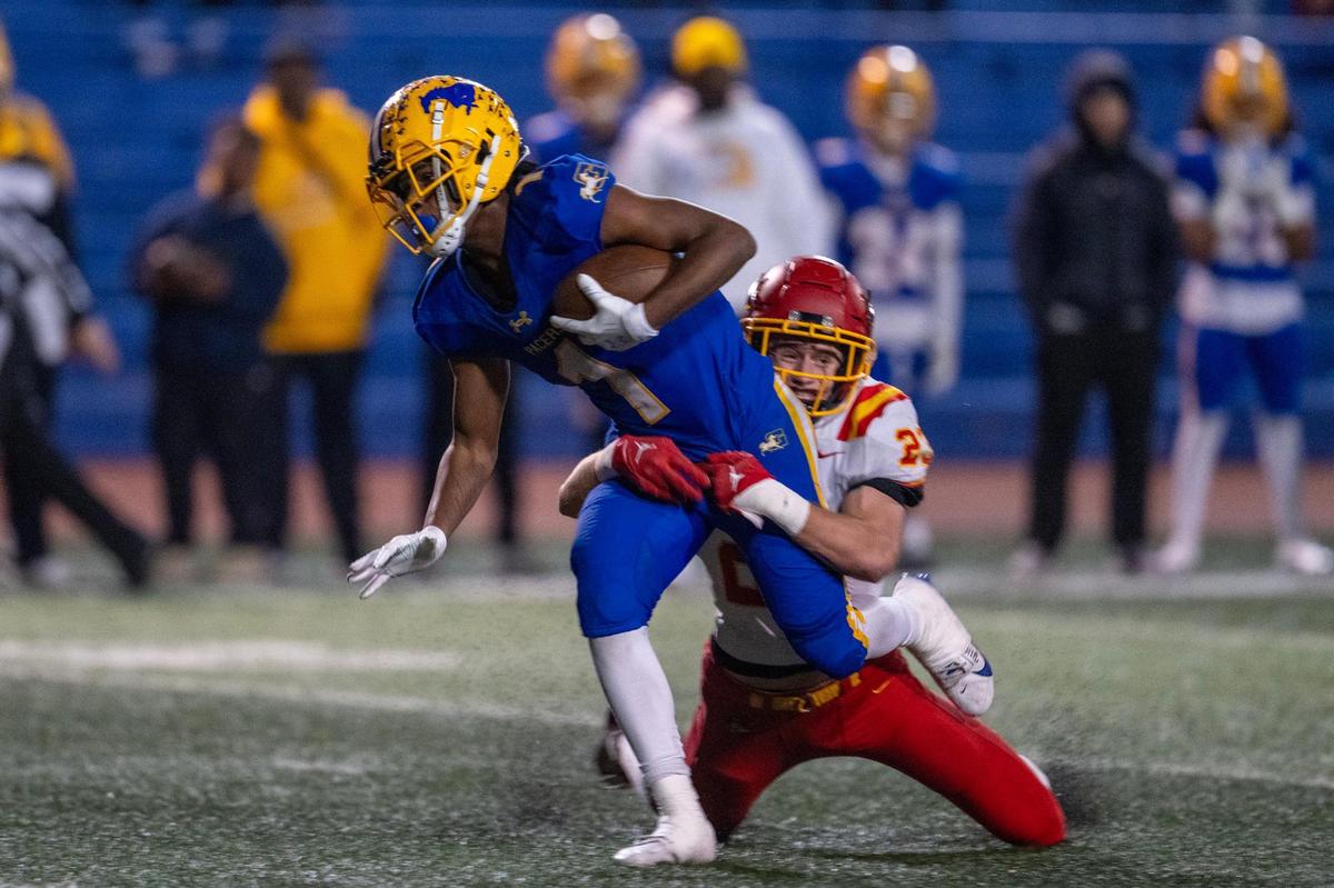 The Grant Pacers’ Brandon Lambert (1) is brought down by the Jesuit Marauders’ Jack Patock (23) after catching a pass in the first half a Sac-Joaquin Section Division II quarterfinal playoff game on Friday, Nov. 15, 2024 in Del Paso Heights.