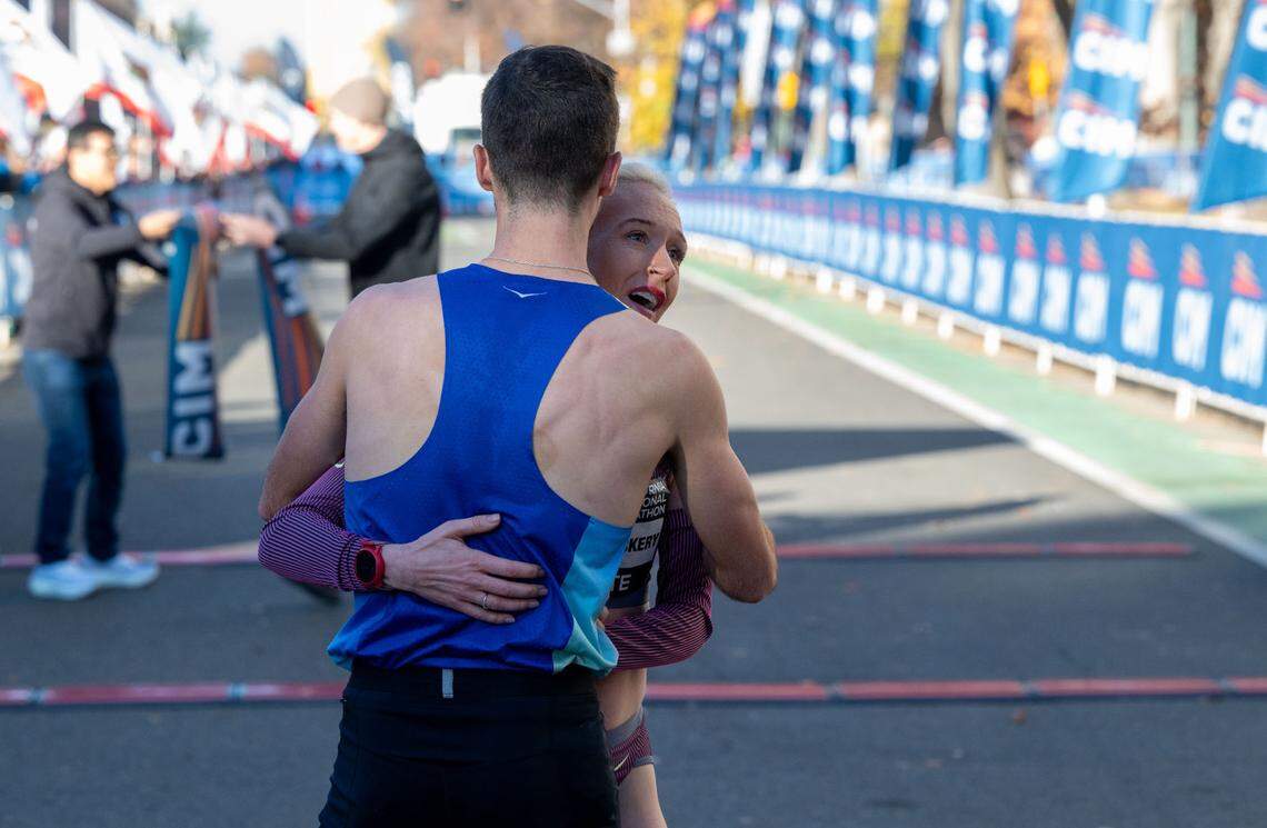 British Olympian Callie Hauger-Thackery is embraced by her husband Nick Hauger as she wins the women’s California International Marathon title on Sunday. Hauger finished third on the men’s side moments earlier.