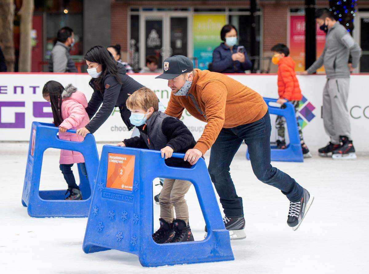 Families use skate aids to help the children circle the Downtown Sacramento Ice Rink at Ali Youssefi Square at 7th and K streets on Sunday, Nov. 14, 2021. The rink, a city tradition since 1991, did not open last year because of the coronavirus pandemic. Tickets are $6 for kids 6 and under, $13 per skater during regular hours, and $15 per skater during holiday hours. It is open Tuesdays through Sundays through Jan. 16.