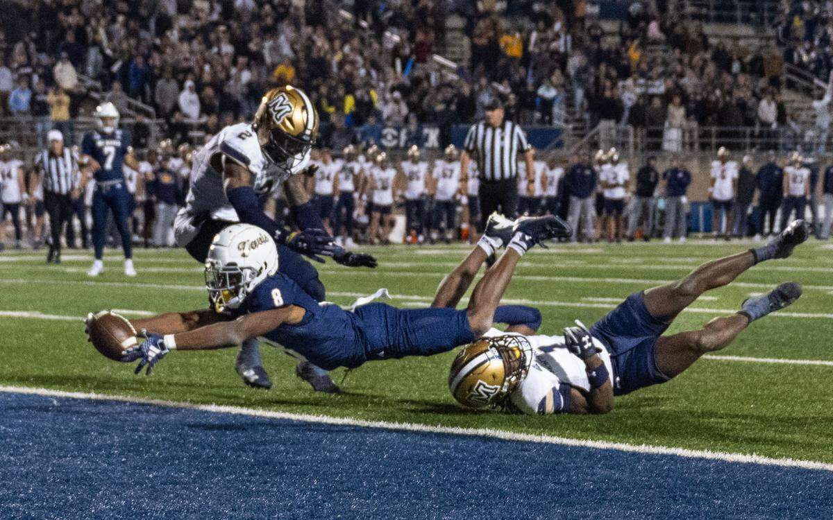 UC Davis Aggies wide receiver Samuel Gbatu Jr. (8) stretches his body into the end zone during a NCAA football game against Montana State Bobcats on Saturday, Nov. 16, 2024 at UC Davis Health Stadium. 