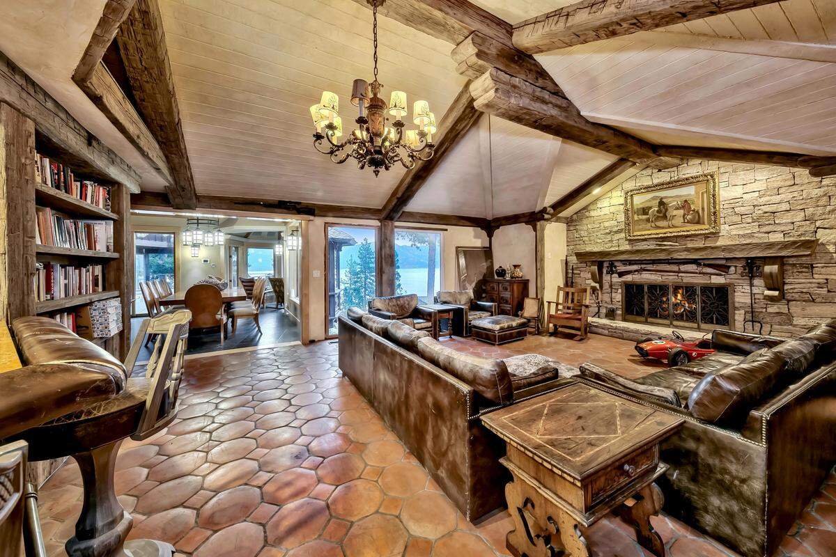 The light-filled main living area is adorned with wood beams salvaged from Sacramento’s first sawmill, an antique Tole chandelier, and timeless European details.