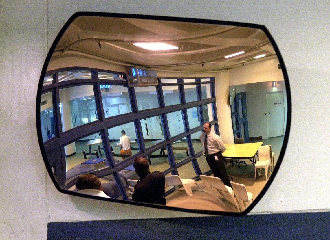 A security mirror reflects an interior area of the Sacramento County Mail Jail in 2002.