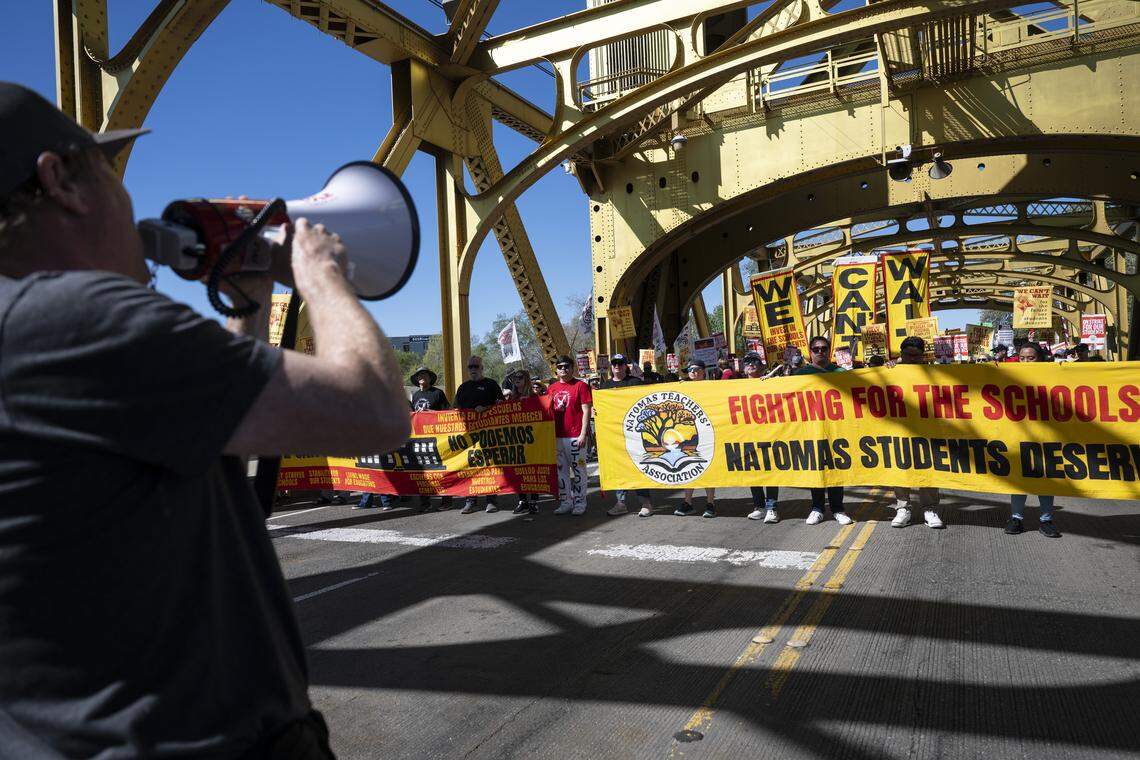 Members of the Natomas Teachers Association and Twin Rivers United Educators march across Tower Bridge in Sacramento on Thursday as a part of their strike against their respective districts.