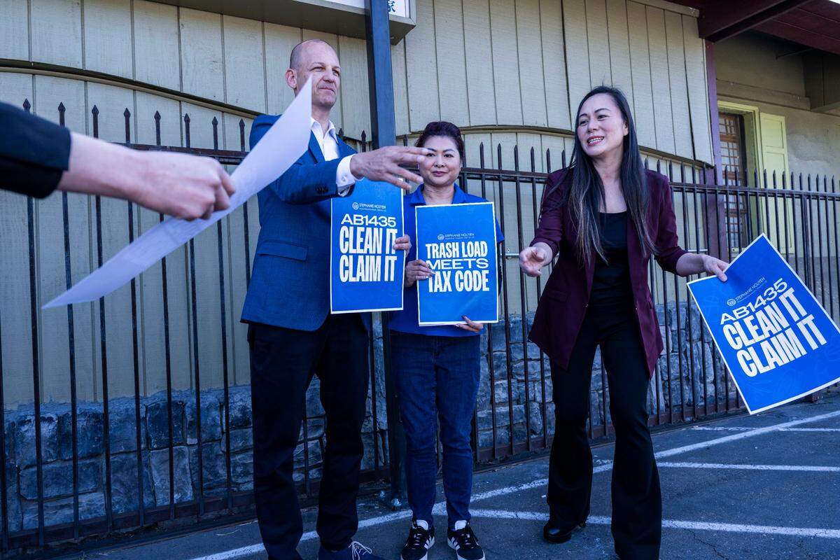 Sacramento Mayor Kevin McCarty, Pho Xe Lua restaurant owner Tina Nguyen and Assemblymember Stephanie Nguyen, D- Elk Grove, prepare for a photo after a press conference on Monday, April 21, 2025, in support of Assembly Bill 1435. The bill would create a tax credit that would allow businesses to deduct expenses for cleaning up encampments and illegal dumping.