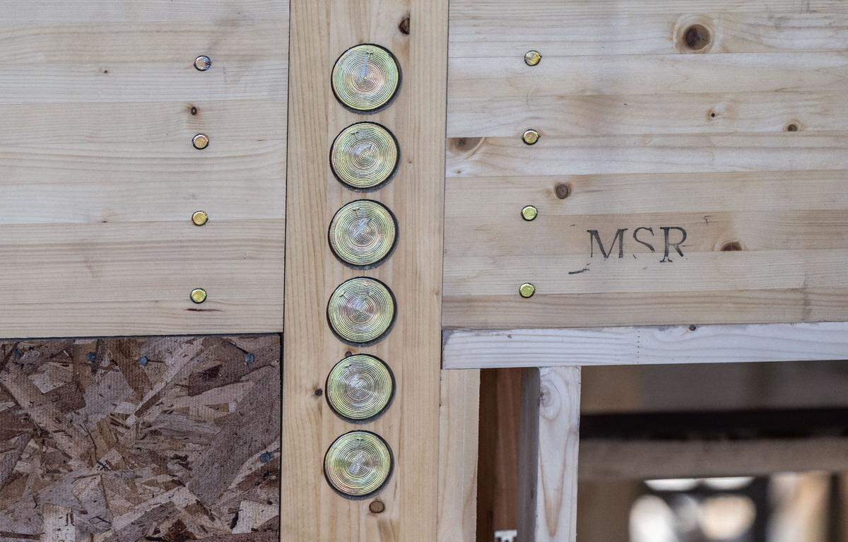 Proprietary metal fittings connect laminated beams to the posts in on Monday in a home under construction in the Sharwood development in Folsom. The sustainable wood is imported from Finland and precision cut before it arrives on site.