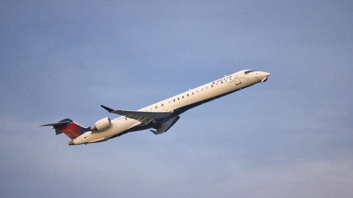 A Delta Air Lines co-pilot authorized to carry a firearm threatened to shoot a pilot if he diverted a flight for a medical emergency, federal officials say.