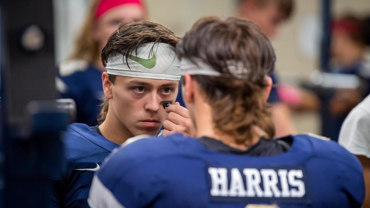 Elk Grove Thundering Herd Carter Harris (2), apples face paint before the game as they host the Cosumnes Oaks Wolfpack at Elk Grove High School, Friday, Oct. 25, 2019.