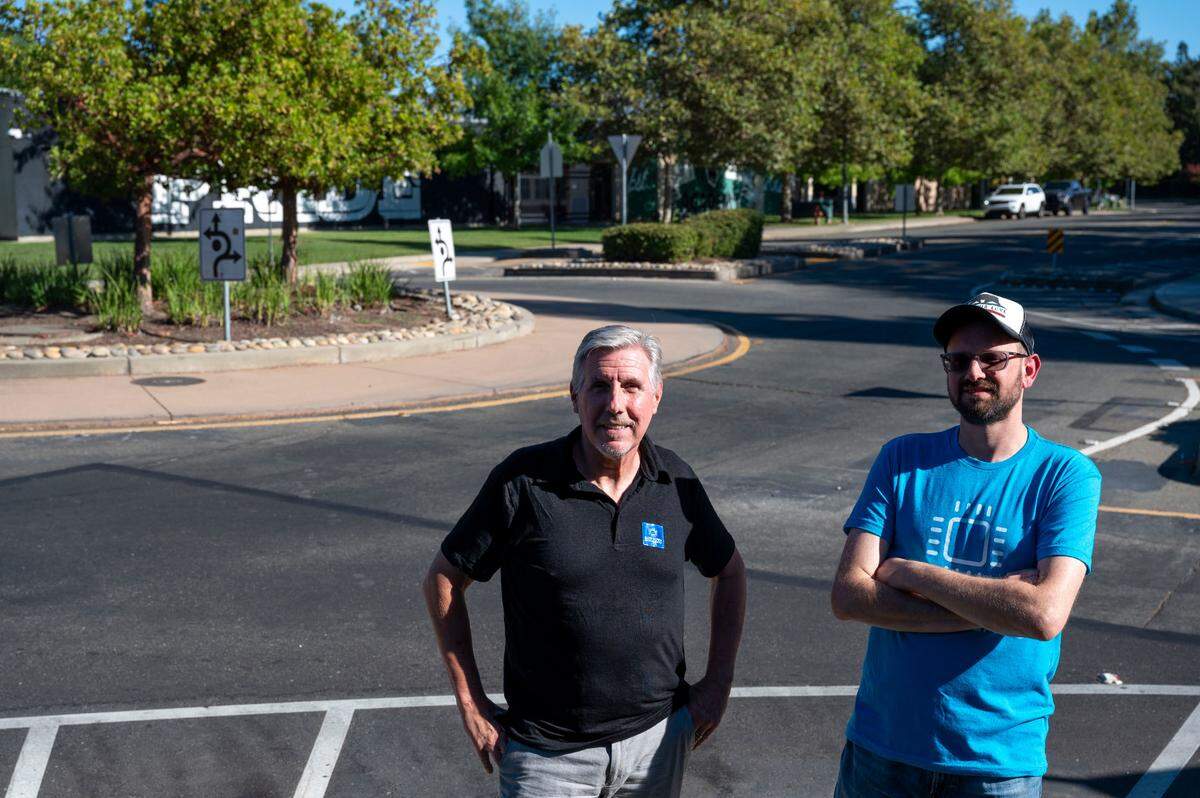 Matt Malkin, left, and Jerry Champa&nbsp;stand near an intersection with a roundabout to slow traffic by a school in Natomas on Monday. They started a coalition and asked city leaders to apply for a safety grant from the state for the installation of up to 20 small roundabouts to make Sacramento streets safer.