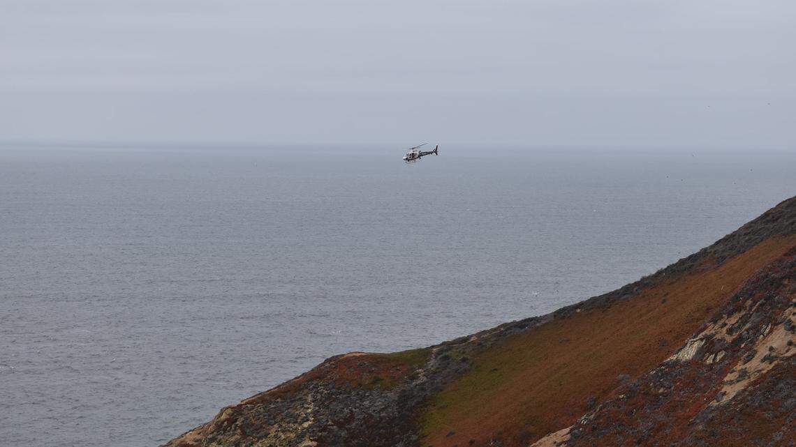 In this photo taken on Sept. 15, 2021, fire crews from Cal Fire CZU work to rescue a driver who flew off Devil’s Slide cliff in Pacifica, California.