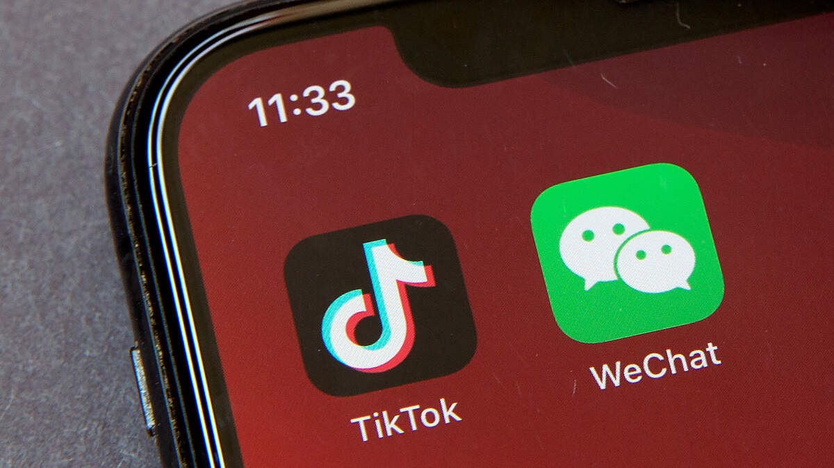 Icons for the smartphone apps TikTok and WeChat are seen on a smartphone screen in Beijing, Friday, Aug. 7, 2020. President Donald Trump ordered a sweeping but unspecified ban on dealings with the Chinese owners of the consumer apps TikTok and WeChat, although it remains unclear if he has the legal authority to actually ban the apps from the U.S. (AP Photo/Mark Schiefelbein)