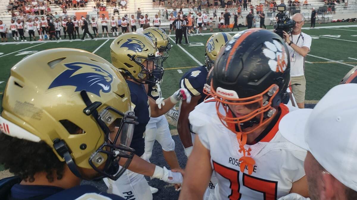 West Park and Roseville captains shake hands before the inaugural football meeting between the two Roseville schools on Friday, Sept. 6, 2024, at West Park High School.