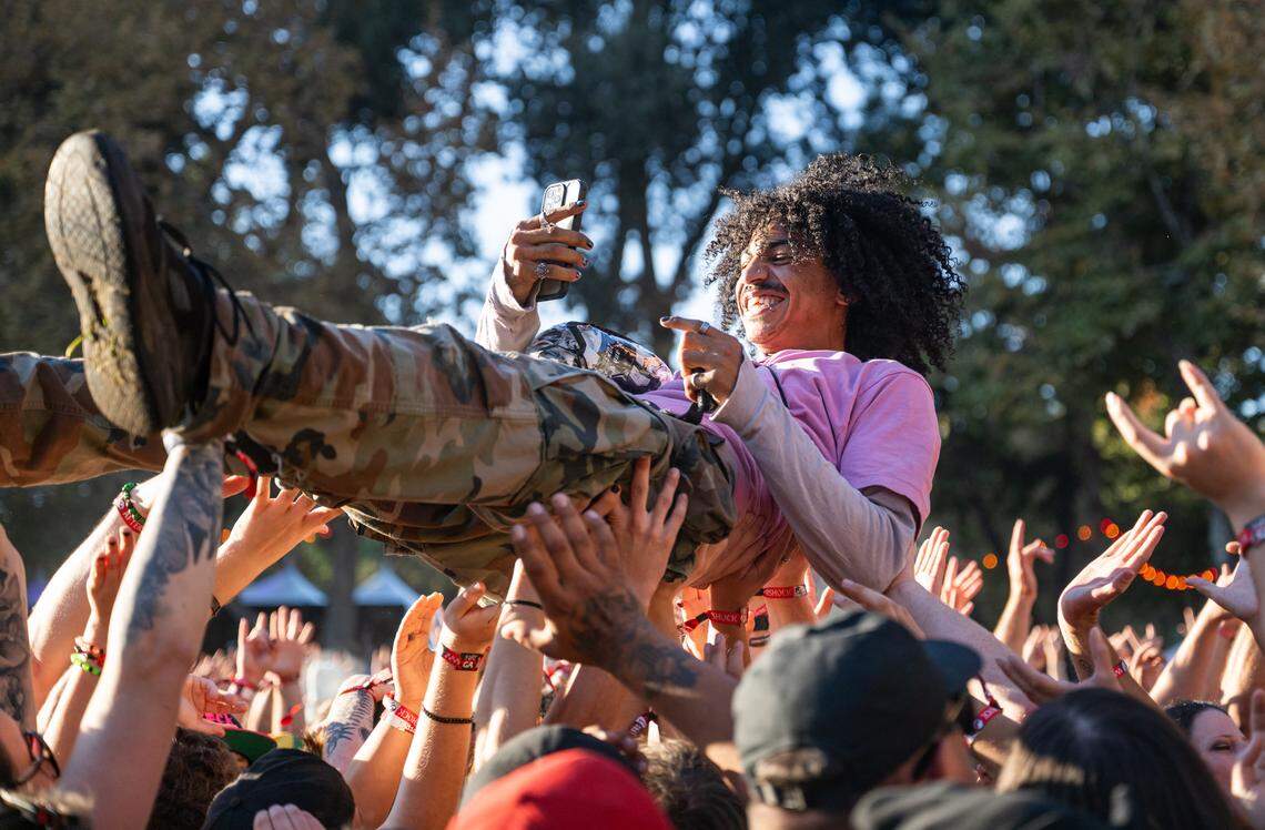 A crowd surfer smiles as he videos his travels during the Aftershock festival on Friday, Oct. 3, 2025, in Discovery Park in Sacramento.  