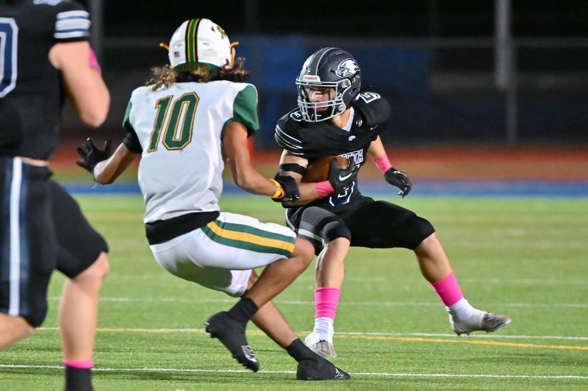 Vista del Lago Eagles safety Camden King (5) makes an interception in the first half of the game on Friday at Vista Del Lago High School in Folsom.