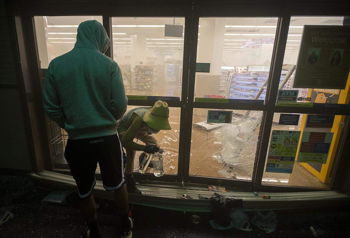Bottles of alcohol are stolen from the Rite Aid at 827 K Street in downtown Sacramento in May 2020, after a protest about the killing of George Floyd by Minneapolis police officers.