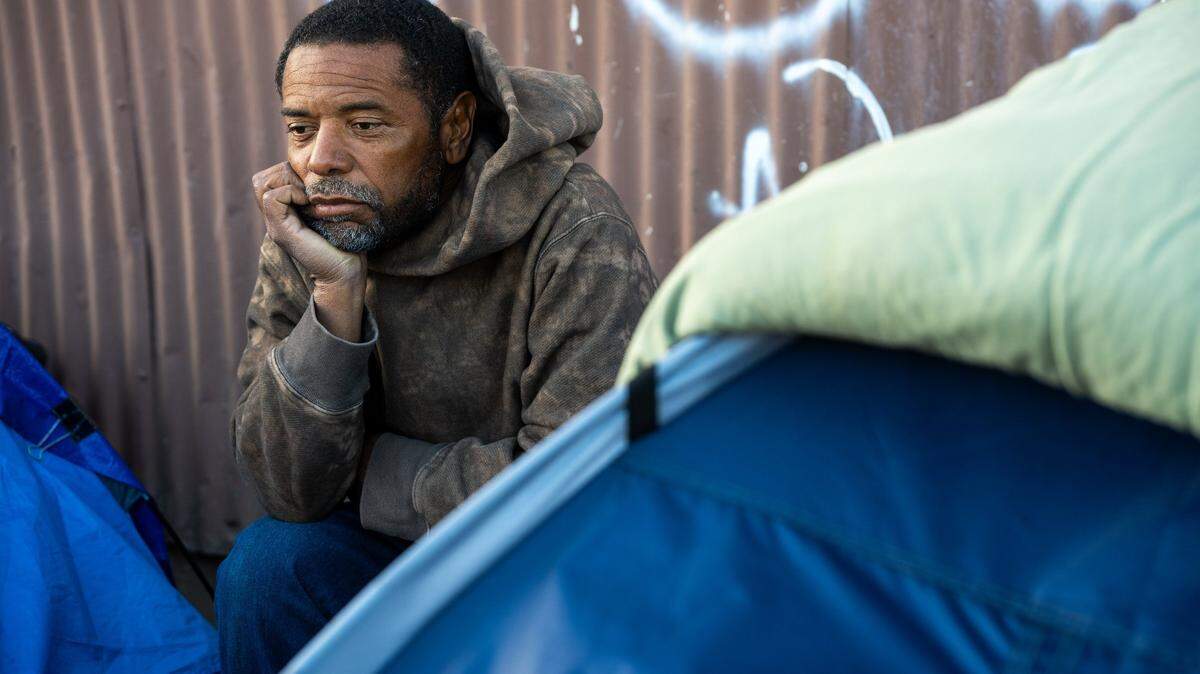 Ron Green sits near his tent in Sacramento.